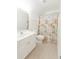 Bright bathroom featuring a white vanity, toilet, and shower with beach-themed curtain at 2474 Starfire Ln, Loganville, GA 30052