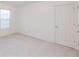 This bedroom features neutral carpeting, a window for natural light, and a closet at 2474 Starfire Ln, Loganville, GA 30052
