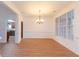 Well-lit dining room featuring new wood flooring and classic chandelier fixture at 2474 Starfire Ln, Loganville, GA 30052