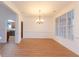 Dining area featuring a chandelier, hardwood floors and natural light from large windows at 2474 Starfire Ln, Loganville, GA 30052