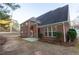 Brick home with a large backyard with trees and a concrete patio off the back door at 2474 Starfire Ln, Loganville, GA 30052