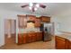 Spacious kitchen with stainless steel refrigerator, granite countertops, and hardwood floors at 2474 Starfire Ln, Loganville, GA 30052