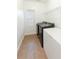 Bright laundry room features tile floors, newer appliances, a window and storage shelf at 2474 Starfire Ln, Loganville, GA 30052