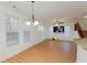 Bright living space featuring hardwood floors, large windows, and a staircase at 2474 Starfire Ln, Loganville, GA 30052