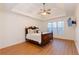 Spacious main bedroom with hardwood floors, ceiling fan, trey ceiling, and natural light at 2474 Starfire Ln, Loganville, GA 30052