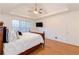 Spacious main bedroom with hardwood floors, trey ceiling, ceiling fan, and a wall-mounted TV at 2474 Starfire Ln, Loganville, GA 30052