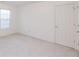 Neutral spare bedroom featuring plush carpet and a double door closet at 2474 Starfire Ln, Loganville, GA 30052