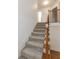 Carpeted staircase with wood railings leads to the upper level of the home at 2474 Starfire Ln, Loganville, GA 30052