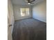 Bedroom with gray carpet, neutral walls, a ceiling fan and a window letting in plenty of natural light at 2878 Belfaire Lake Dr, Dacula, GA 30019