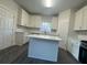 Well-lit kitchen with white cabinets, a center island, stainless steel appliances, and modern finishes at 2878 Belfaire Lake Dr, Dacula, GA 30019