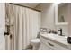 Cozy bathroom featuring a toilet, sink, and bathtub with shower curtain at 504 Leguin Mill Rd, Locust Grove, GA 30248