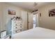 Comfortable bedroom with white furniture, neutral paint, and door access at 504 Leguin Mill Rd, Locust Grove, GA 30248