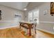 Charming dining room with a rustic wooden table, bench seating, and bright natural light for cozy Gathering meals at 504 Leguin Mill Rd, Locust Grove, GA 30248