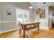 Bright dining area with a farmhouse-style table, rustic decor, and ample natural light for cozy and inviting gatherings at 504 Leguin Mill Rd, Locust Grove, GA 30248