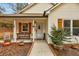 Inviting front porch featuring a bench, decorative plants, and rustic wooden shutters for a warm, welcoming curb appeal at 504 Leguin Mill Rd, Locust Grove, GA 30248