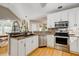 Kitchen featuring stainless steel appliances, double sink and mosaic backsplash at 504 Leguin Mill Rd, Locust Grove, GA 30248