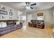 Bright living room with hardwood floors, two sofas, and a view of the dining area for comfortable living and entertaining at 504 Leguin Mill Rd, Locust Grove, GA 30248