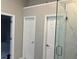 Bathroom featuring a glass shower and two doors for privacy at 6910 Stone Breeze Dr, Stone Mountain, GA 30087