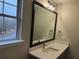 Modern bathroom features a large mirror, contemporary lighting, and a stylish vanity with stone countertop at 6910 Stone Breeze Dr, Stone Mountain, GA 30087