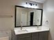 Bathroom featuring a double sink vanity, a large mirror, and elegant lighting fixtures at 6910 Stone Breeze Dr, Stone Mountain, GA 30087