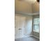 Bedroom featuring a tray ceiling, neutral walls, closet, and a window with natural lighting at 6910 Stone Breeze Dr, Stone Mountain, GA 30087