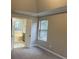 Bedroom featuring an ensuite bathroom, plush carpet, and a window providing natural light at 6910 Stone Breeze Dr, Stone Mountain, GA 30087