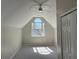 Upstairs bedroom features a large window, closet and fresh gray paint and carpet at 6910 Stone Breeze Dr, Stone Mountain, GA 30087