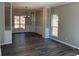 Dining room featuring gray wood flooring, crown molding, and natural lighting at 6910 Stone Breeze Dr, Stone Mountain, GA 30087