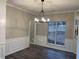 Bright dining room featuring a modern chandelier and views from the large window at 6910 Stone Breeze Dr, Stone Mountain, GA 30087