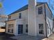 Back of a two-story home with gray siding, a patio and many windows at 6910 Stone Breeze Dr, Stone Mountain, GA 30087