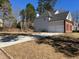 Two-story home featuring a brick and siding facade with a two-car garage at 6910 Stone Breeze Dr, Stone Mountain, GA 30087