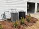 Exterior shot of two AC units, with the garage in the background at 6910 Stone Breeze Dr, Stone Mountain, GA 30087