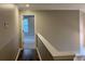 Upstairs hallway featuring wood floors that lead to a bedroom filled with natural light at 6910 Stone Breeze Dr, Stone Mountain, GA 30087