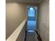 The hallway features neutral colored walls, white trim, closet, and an arched window for bright light and charm at 6910 Stone Breeze Dr, Stone Mountain, GA 30087