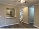 View of the living room showcasing hardwood floors, staircase, and kitchen at 6910 Stone Breeze Dr, Stone Mountain, GA 30087