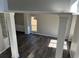 Bright living room featuring stylish gray wood flooring and modern architectural pillars at 6910 Stone Breeze Dr, Stone Mountain, GA 30087