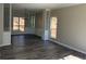 Open-concept living room featuring hard surface floors, light gray walls, built-in shelving and plenty of natural light at 6910 Stone Breeze Dr, Stone Mountain, GA 30087