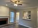 Cozy living room featuring a brick fireplace, large window, and an opening to the kitchen, perfect for entertaining at 6910 Stone Breeze Dr, Stone Mountain, GA 30087