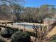 Community pool enclosed by a black fence and surrounded by lush greenery at 6910 Stone Breeze Dr, Stone Mountain, GA 30087