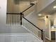 Elegant staircase with white balusters and contrasting dark wood handrail at 6910 Stone Breeze Dr, Stone Mountain, GA 30087