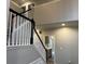 Staircase leading to a second-floor landing, with views into the kitchen at 6910 Stone Breeze Dr, Stone Mountain, GA 30087