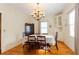 Elegant dining room with hardwood floors, a large window, and a stylish chandelier at 814 Oak Moss Dr, Lawrenceville, GA 30043