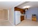 Compact kitchen with wooden cabinets, white appliances, and tile flooring at 814 Oak Moss Dr, Lawrenceville, GA 30043