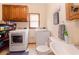 Functional laundry room combined with a half bath and offering ample storage at 814 Oak Moss Dr, Lawrenceville, GA 30043