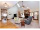 Cozy living room with hardwood floors, skylight, a ceiling fan, and a brick fireplace at 814 Oak Moss Dr, Lawrenceville, GA 30043