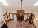 View of the living room with skylights, a ceiling fan, brick fireplace, and access to other rooms at 814 Oak Moss Dr, Lawrenceville, GA 30043