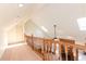 Cozy loft area with skylights and wood railing overlooking the living room with fireplace at 814 Oak Moss Dr, Lawrenceville, GA 30043