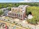 Aerial view of a modern apartment building, featuring a rooftop patio and city skyline at 112 Rogers Ne St # 206, Atlanta, GA 30317