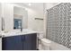 Modern bathroom features a sleek vanity with a white countertop, black fixtures, and a patterned shower curtain at 112 Rogers Ne St # 206, Atlanta, GA 30317