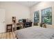 Bright bedroom with a comfortable bed, bench seating, and natural light from the windows, creating a welcoming atmosphere at 112 Rogers Ne St # 206, Atlanta, GA 30317